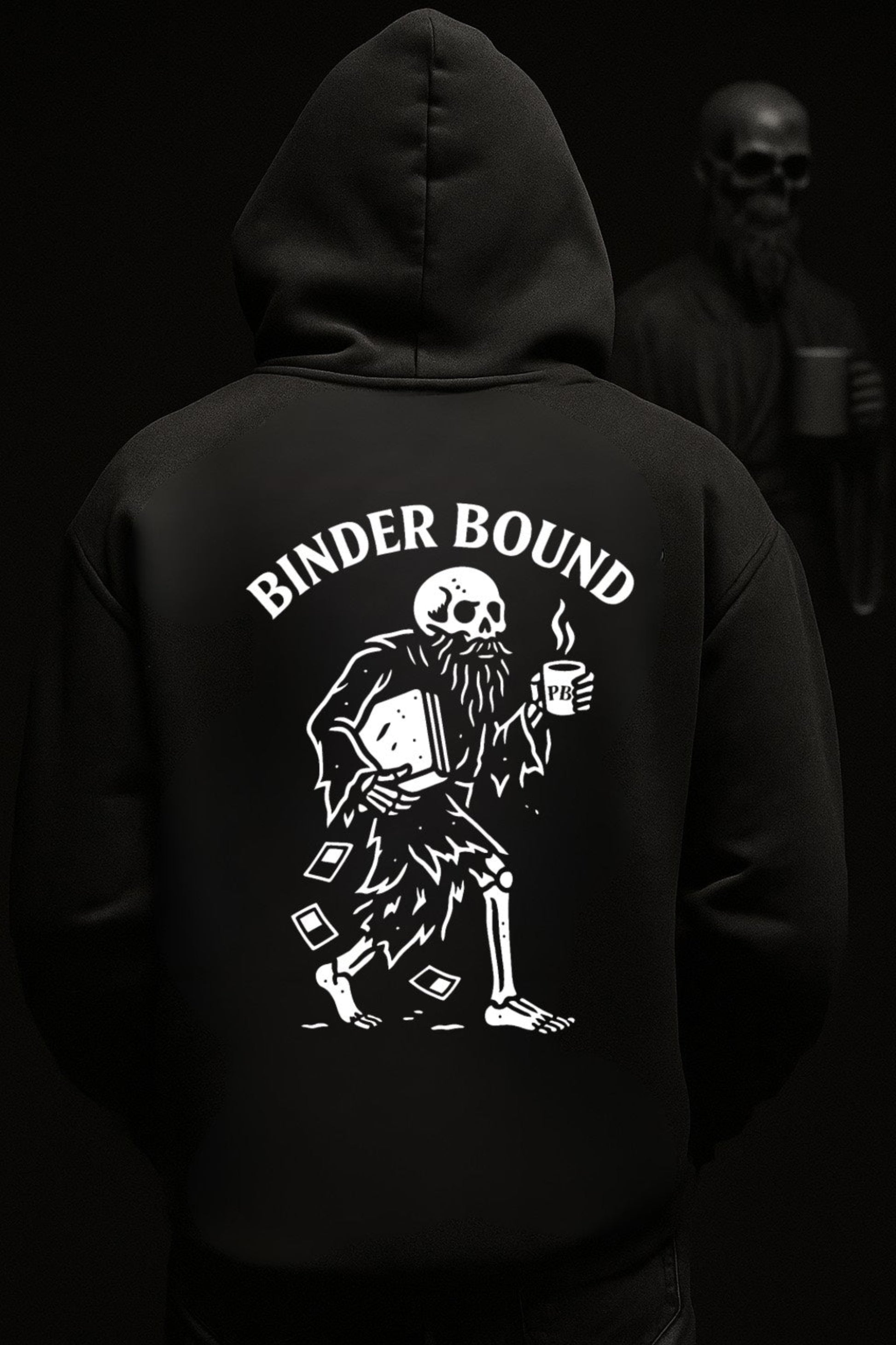 Black hoodie with skeleton design and 'BINDER BOUND' text on the back, worn by a person in a dark setting.