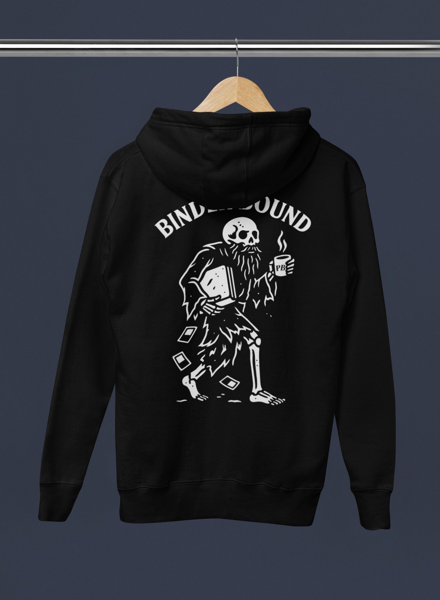 Black hoodie with a skeleton design and 'Binders Bound' text on a hanger against a dark background
