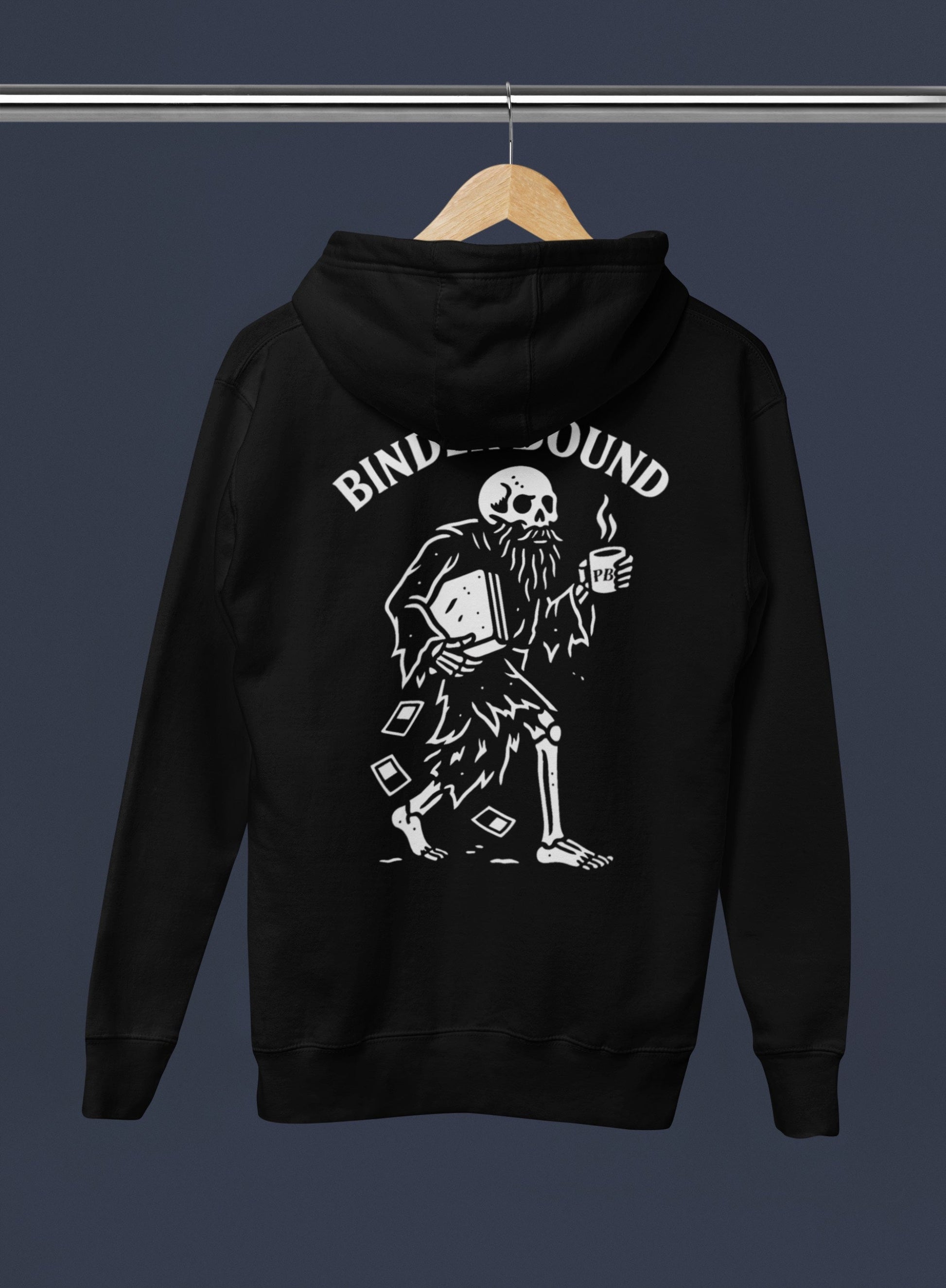 Black hoodie with a skeleton design and 'Binders Bound' text on a hanger against a dark background
